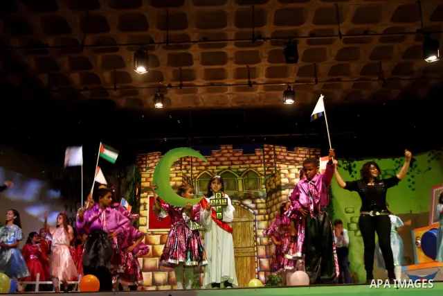 Palestinian children perform in a play marking the 21st anniversary of the signing of the Convention on the Rights of the Child (CRC) during a celebration organized by the United Nations Children's Fund (UNICEF), in Gaza...