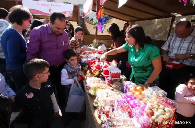 Foreign Christians attend to the opening of the tenth annual of the Christmas market in front of the Church of the Nativity in the West Bank city of Bethlehem on Nov. 29,2010. Photo by Najeh Hashlamoun