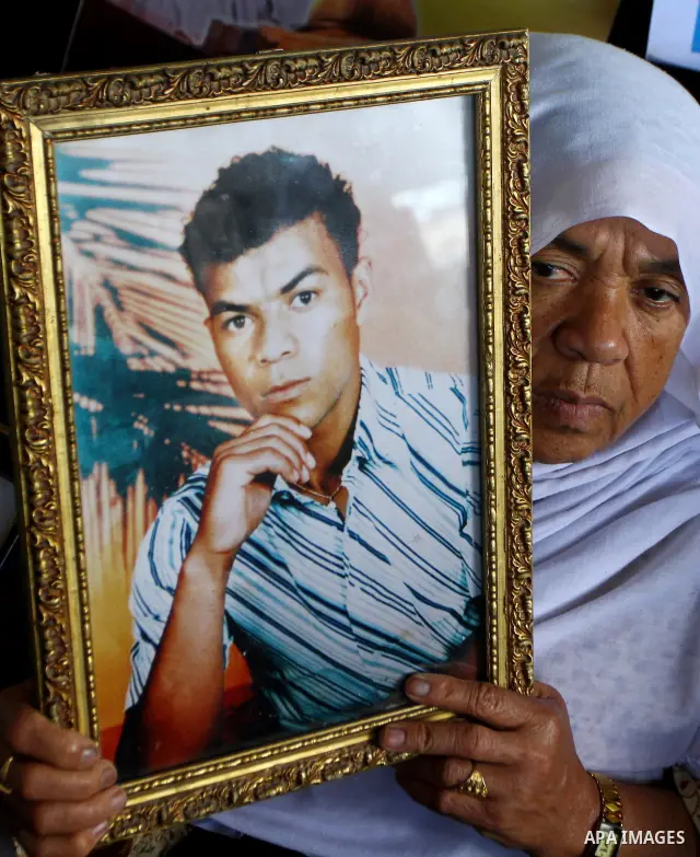 Palestinian women and children hold pictures of jailed relatives during a protest calling for the release of Palestinian prisoners from Israeli jails at the Red Cross office in Gaza City on Nov. 29,2010. Photo by Ashraf...