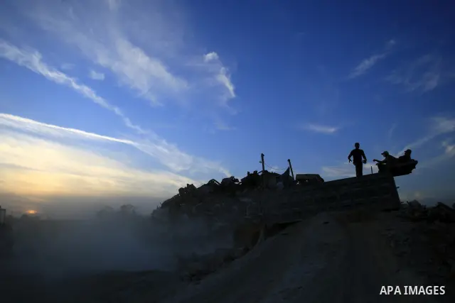 Palestinians work recycling rubble from the remains of ruined Palestinian buildings that were destroyed during the Israeli war against Hamas in the Gaza Strip, near the border between Israel and Gaza strip in the east of...