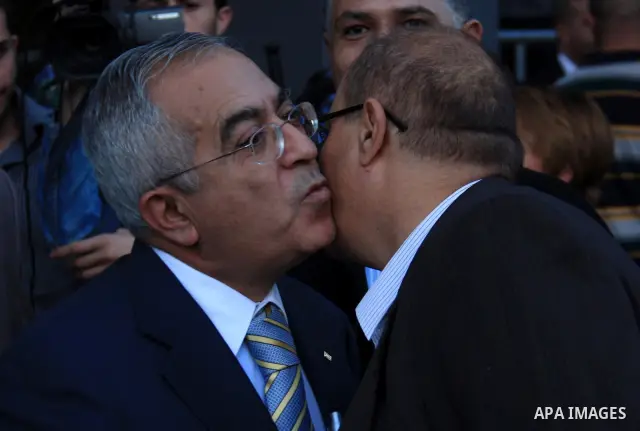 Palestinian Prime Minister Salam Fayyad and Cheif of the U.S. Agency for International Development (USAID), Michael Harvey attend the opening ceremony of a post office in the West Bank city of Nablus, Thursday, on Dec. 2...