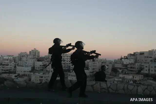 Israeli security forces take up positions during clashes with Palestinian youths in the east Jerusalem neighborhood of Issawiyeh, Friday, Dec. 3, 2010. The clashes started after a protest against Israel's house demolitio...