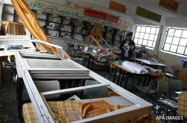 A Palestinian man inspects a classroom at Tunis school after it was damaged when Israeli air force bombed a nearby Hamas facility in Gaza City on December 9, 2010 along with 3 other sites in the territory after Palestini...