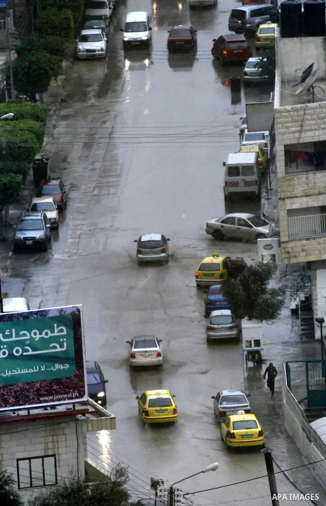 Cars are seen in a street during the heavy rain at the beginning of winter in the West Bank city of Nablus, Saturday, on December 11,2010. Photo by Wagdi Eshtayah