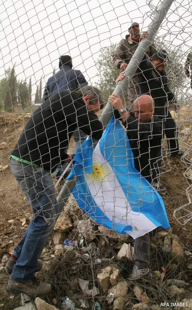 Palestinian, Israeli and foreign activists take part in a demonstration against Israel's separation barrier near the Palestinian village of Beit Omar, just north of the West Bank town of Hebron on December 11, 2010.. Pho...