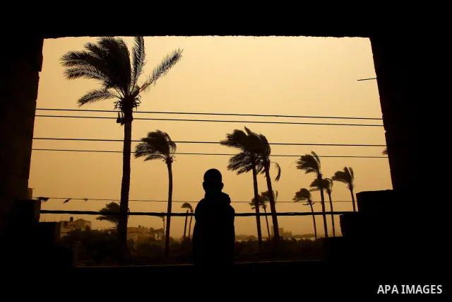 A Palestinian child plays during cold winds and sand storms in the central Gaza Strip town of Deir Al-Balah on Dec. 12,2010. Photo by Ashraf Amra
