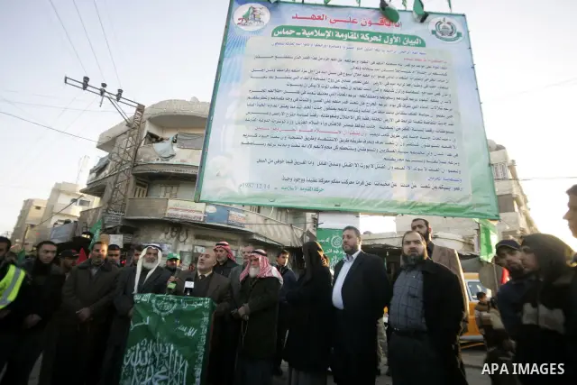 Palestinian Hamas supporters attend the announcement of the largest copy of the first statement of participation of the founders of the Islamic movement Hamas in the preparation of the anniversary of Hamas Islamic moveme...