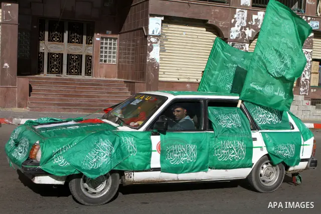 Palestinian Hamas supporters hold the green Islamic Hamas flags in their way to mark the upcoming 23rd anniversary since the group's foundation, in Gaza city, Tuesday, Dec. 14, 2010. Photo by Ashraf Amra