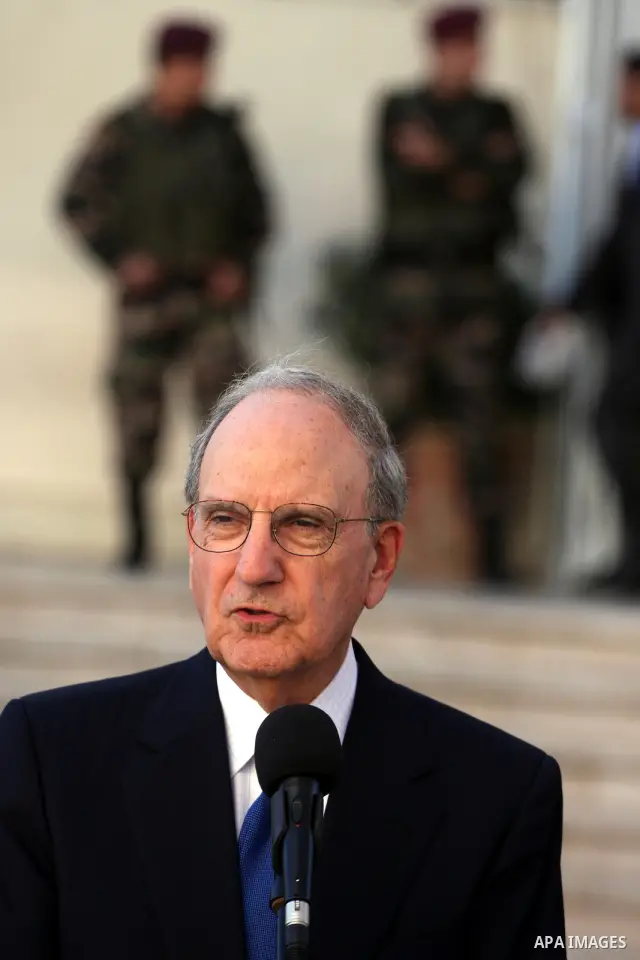 U.S. Middle East peace envoy George Mitchell and the chief Palestinian negotiator Saeb Erekat (not seen) attend a press conference after Mitchell meeting with President Mahmoud Abbas in the West Bank city of Ramallah Dec...