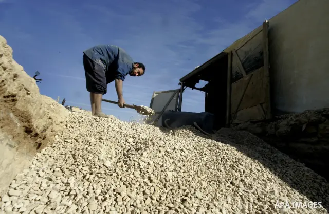 Palestinian men smuggle gravels into the Gaza Strip through a tunnel under the Egypt-Gaza border in Rafah on Dec. 16, 2010. Israel's blockade of the Gaza Strip was imposed after the militant Hamas group violently seized...