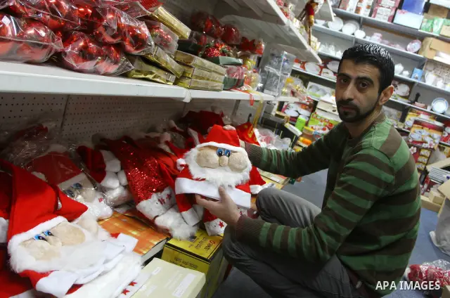 A Palestinian man displays products especially for the Christian Christmas day at his shop in Gaza City on Dec. 18, 2010. Photo by Ashraf Amra