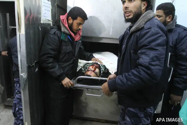 Palestinians look at the body of a Palestinian killed during an Israeli attack, at the morgue of al-Aqsa hospital in Deir al Balah center Gaza strip on December 19, 2010. Five Palestinians were killed as Israeli warplane...