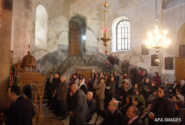 An orthodox christians pray in the Church of the Nativity in the biblical West Bank city of Bethlehem on December 19, 2010 as part of the preparations for the Orthodox faith's Christmas celebrations. The Orthodox faith i...