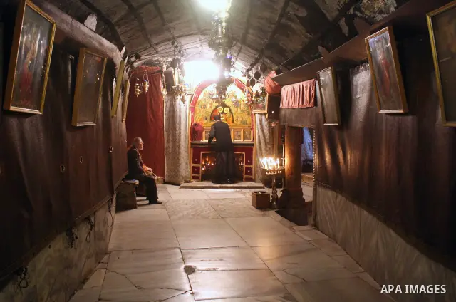 An orthodox priest cleans in the 'Grotto,' or cave in the Church of the Nativity in the biblical West Bank city of Bethlehem on December 19, 2010 as part of the preparations for the Orthodox faith's Christmas celebration...