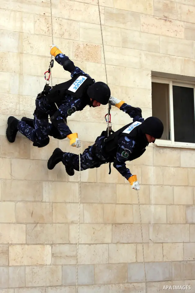 Members of the Palestinian police forces demonstrate their skills during a graduation ceremony in the West Bank city of Ramallah, on December 19, 2010. Photo by Issam Rimawi