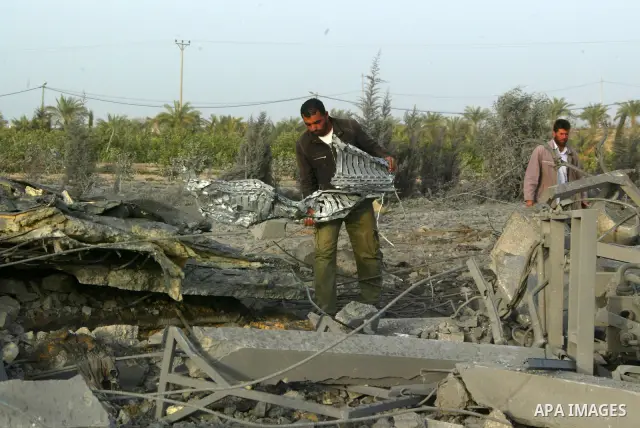 Palestinians inspect the damage at a factory of the Albanians after an Israeli air strike overnight in southern Gaza Strip town of Khan Yunis, on December 21, 2010. After Israeli warplanes staged four attacks in Gaza ove...