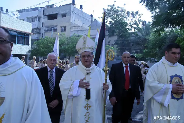 Latin Patriarch of Jerusalem Fouad Twal , (C) , is greeted at the Deir Al Latin Catholic Church in Gaza City, Wednesday, Dec. 22, 2010. Twal arrived in Gaza on Wednesday to attend a celebration with Palestinians ahead of...