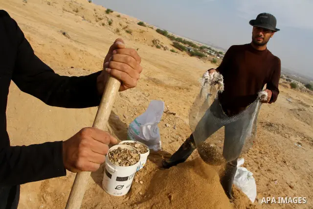 Palestinian workers collect stones to be used for building houses, in the northern Gaza Strip near volatile Erez Crossing with Israel on December 23,2010. As the coastal Palestinian territory continues to lack most const...