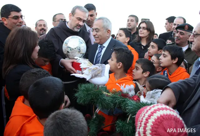 Palestinian Prime Minister Salam Fayyad takes part during a Christmas parade in the West Bank city of Bethlehem on 23 December 2010. Scores of Christian pilgrims are preparing to gather in the traditional birthplace of J...