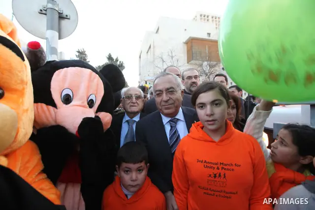 Palestinian Prime Minister Salam Fayyad participates in the academy of children without borders rally in the West Bank city of Bethlehem on Dec. 23,2010. Photo by Mustafa Abu Dayeh