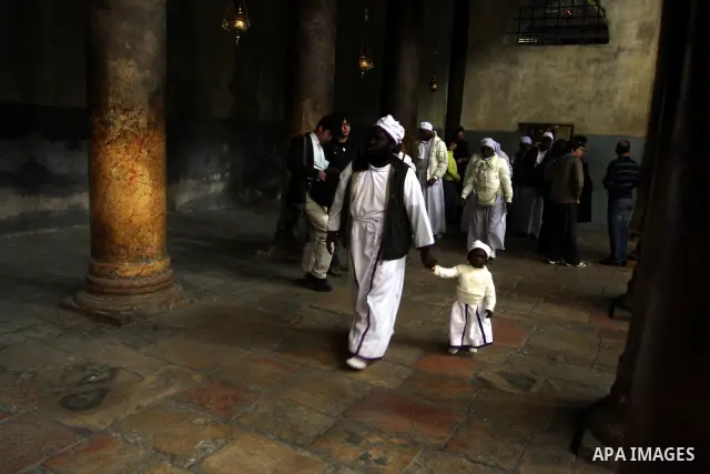 Nigerian Christian pilgrims gather for prayers at the Church of the Nativity, believed to be the birthplace of Jesus Christ, in the West Bank town of Bethlehem on December 24, 2010 as the Holy Land prepared to mark Chris...