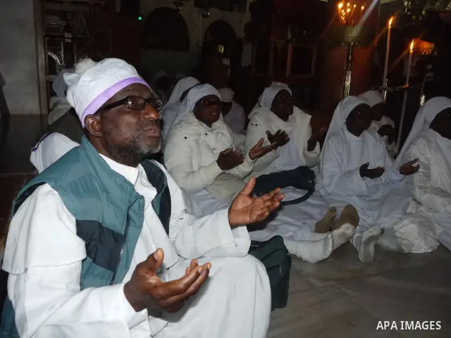 Nigerian Christian pilgrims gather for prayers at the Church of the Nativity, believed to be the birthplace of Jesus Christ, in the West Bank town of Bethlehem on December 24, 2010 as the Holy Land prepared to mark Chris...
