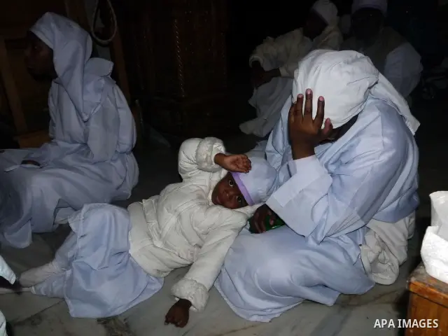 Nigerian Christian pilgrims gather for prayers at the Church of the Nativity, believed to be the birthplace of Jesus Christ, in the West Bank town of Bethlehem on December 24, 2010 as the Holy Land prepared to mark Chris...