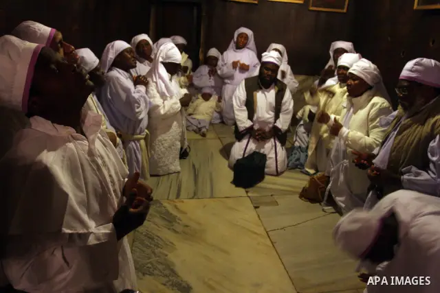 Nigerian Christian pilgrims gather for prayers at the Church of the Nativity, believed to be the birthplace of Jesus Christ, in the West Bank town of Bethlehem on December 24, 2010 as the Holy Land prepared to mark Chris...