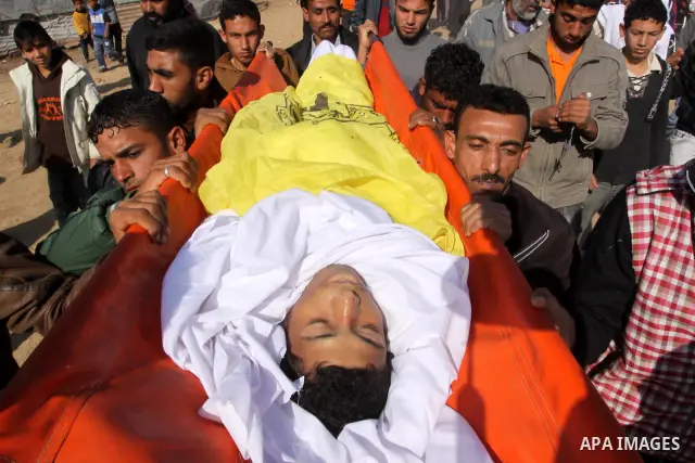 Palestinian mourners carry the body of Salama Abu Hashish, 22, during his funeral in Umm Nasser, in the northern Gaza Strip , Friday, Dec. 24, 2010. A Palestinian medic said Abu Hashish was leading his goats in an open a...