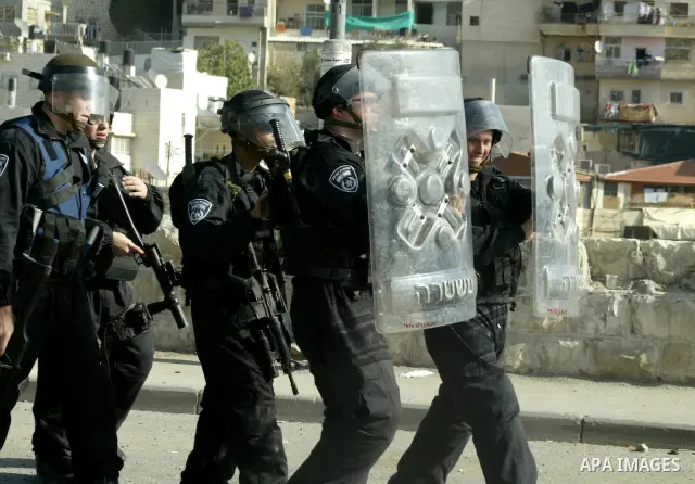 Israeli policemen stand guard during clashes with Palestinian youths in the Arab east Jerusalem neighbourhood of Silwan against Jewish settlement activity in the Palestinian districts of the holy city on December 24, 201...