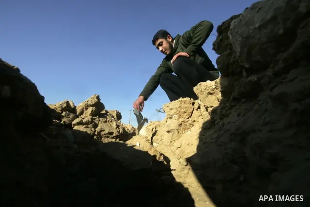A Palestinian man inspects the damage to a smuggling tunnel which was targeted during an Israeli air strikes overnight in southern Gaza Strip town of Rafah, on December 25, 2010. Photo by Abed Rahim Khatib