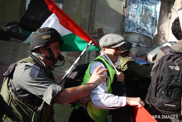 Israeli soldiers stop Palestinian ,Israeli and International activists who attempt to demonstrate against the closure of Shuhada Street in the West Bank city of Hebron on December 25, 2010. Photo by Najeh Hashlamoun