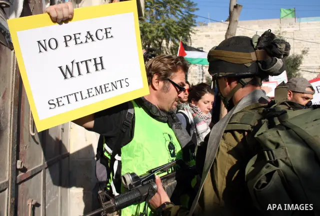 Israeli soldiers stop Palestinian ,Israeli and International activists who attempt to demonstrate against the closure of Shuhada Street in the West Bank city of Hebron on December 25, 2010. Photo by Najeh Hashlamoun