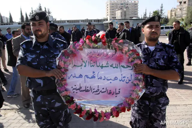 Palestinian policemen lay a wreath on the tomb of the martyrs of the policemen who were killed during the Israeli war on Gaza Strip 2008-2009, Gaza City on Dec. 27,2010. as they mark the second anniversary of the Israeli...