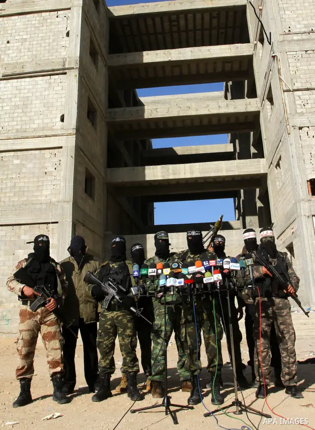 Masked Palestinian militants of the Popular Resistance Committee attend a press conference to mark the 2nd anniversary of the Israeli war on Gaza, in Gaza City, Dec. 27, 2010. A Fatah senior member on Monday called on Is...