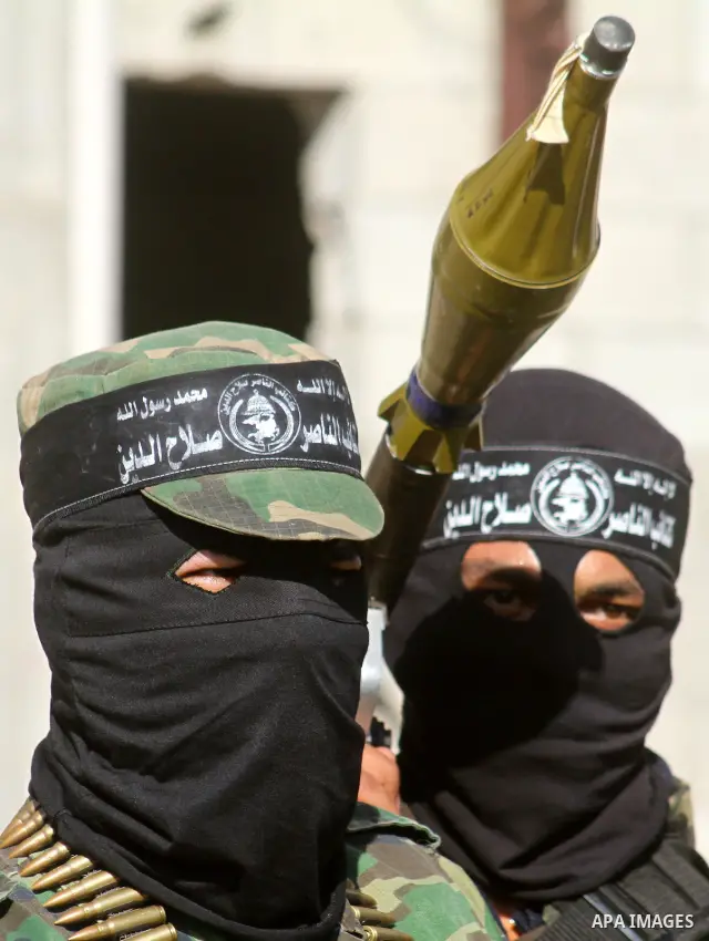 Masked Palestinian militants of the Popular Resistance Committee attend a press conference to mark the 2nd anniversary of the Israeli war on Gaza, in Gaza City, Dec. 27, 2010. A Fatah senior member on Monday called on Is...