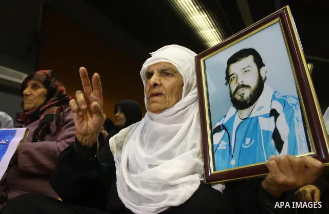 Palestinians hold pictures of their prisoned relatives in Israeli jails as they take part in a celebration in Gaza City, Dec. 28, 2010. About 7000 prisoners are in Israeli jails according to the Palestinian prisoners min...