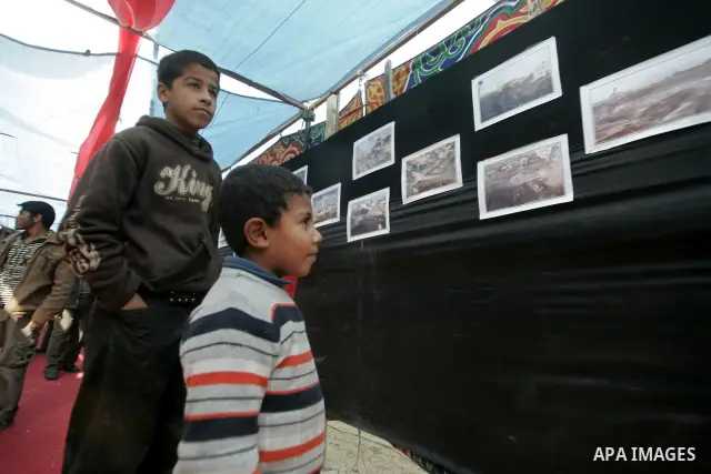 Palestinian children attend an exhibition organized by Hamas marks the second anniversary of Israel's three-week offensive on Gaza, in the southern Gaza Strip town of Rafah on December 29, 2010. Which more than a thousan...