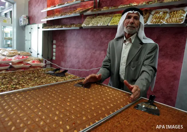 A Palestinian man displays sweets at his shop in the Jerusalem's old city on December 28, 2010. Mahfouz Abu Turk