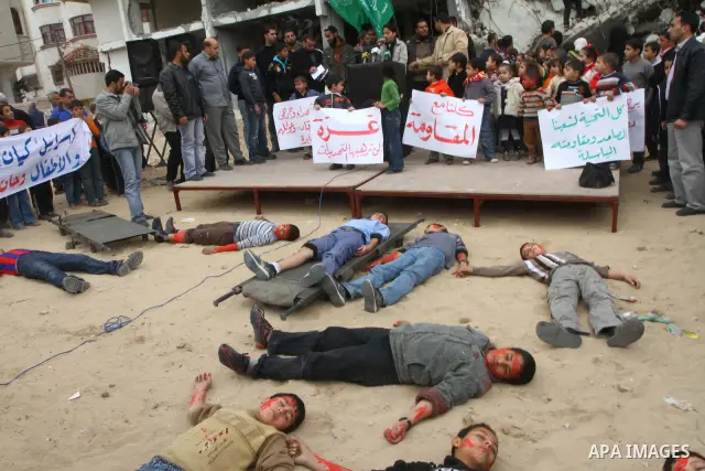 Palestinians take part in a reenactment of an Israeli strike during a performance organized by Hamas, marking the 2nd anniversary of the Israel-Gaza war, in Gaza City, Thursday, Dec. 30, 2010. The three-week offensive dr...
