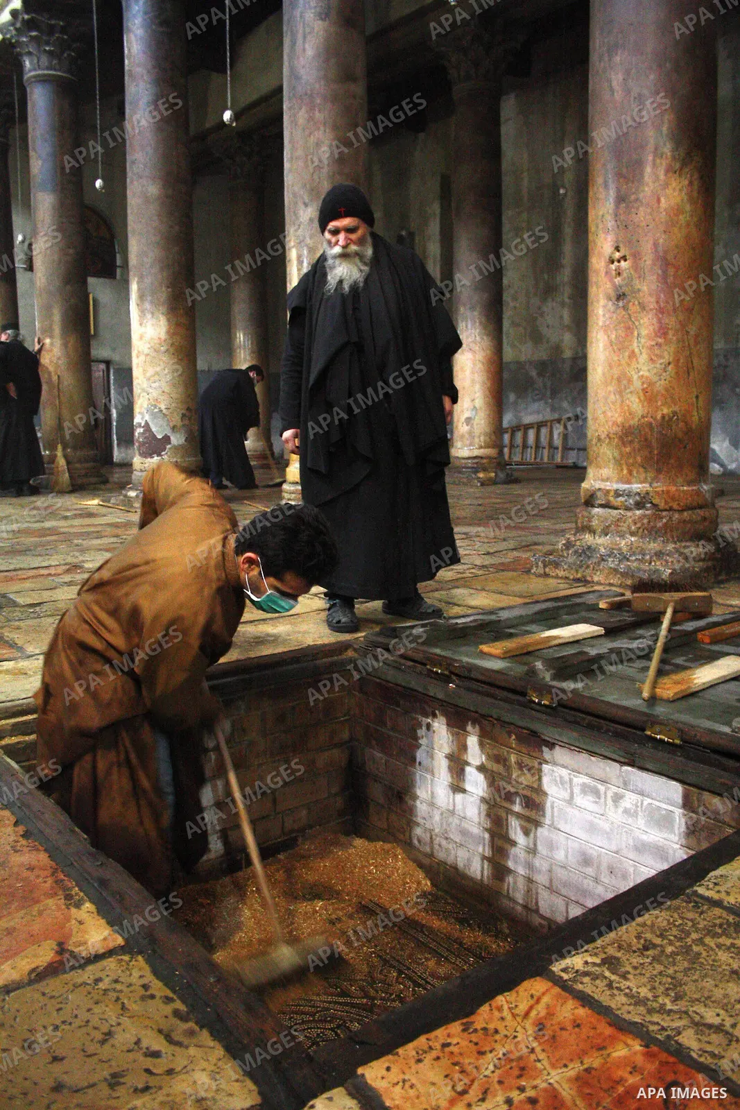 Orthodox priests clean the Church of the Nativity in the biblical West Bank city of Bethlehem on December 30, 2010 as part of the preparations for the Orthodox faith's Christmas celebrations. The Orthodox faith in the ho...