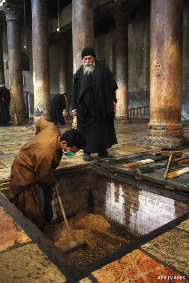 Orthodox priests clean the Church of the Nativity in the biblical West Bank city of Bethlehem on December 30, 2010 as part of the preparations for the Orthodox faith's Christmas celebrations. The Orthodox faith in the ho...