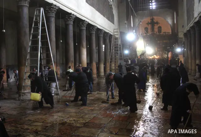 Orthodox priests clean the Church of the Nativity in the biblical West Bank city of Bethlehem on December 30, 2010 as part of the preparations for the Orthodox faith's Christmas celebrations. The Orthodox faith in the ho...