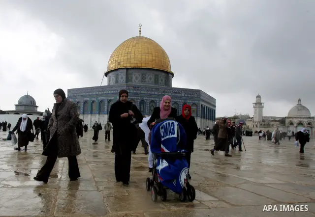 Palestinian Muslims walk in front of the Dome of Rock to attend Friday prayers in the Al Aqsa Mosque compound, also known to Jews as the Temple Mount, in Jerusalem's old city on Dec. 31, 2010. Photo by Mahfouz Abu Turk