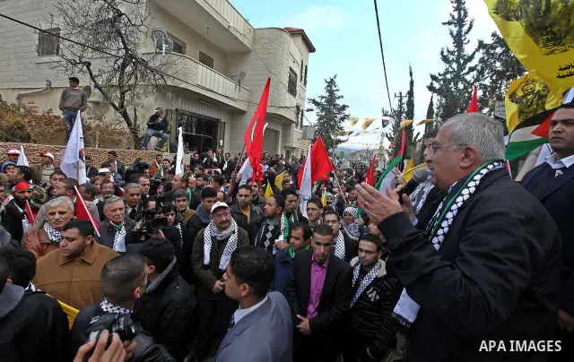Palestinian Prime Minister, Salam Fayyad take part in a protest against Israel's separation barrier outside the West Bank village of Bilin, near Ramallah, Friday, Dec 31, 2010. Israel says the barrier is necessary for se...