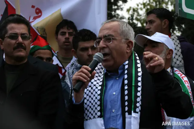 Palestinian Prime Minister, Salam Fayyad take part in a protest against Israel's separation barrier outside the West Bank village of Bilin, near Ramallah, Friday, Dec 31, 2010. Israel says the barrier is necessary for se...