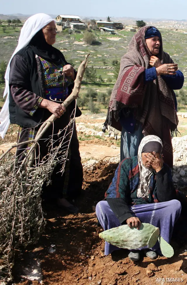 Palestinians are trying to retrieve items from the rubble of their family house after it was destroyed by Israeli army tractors early on 22 February 2011 in the West Bank village of Yatta near Hebron. The house was locat...