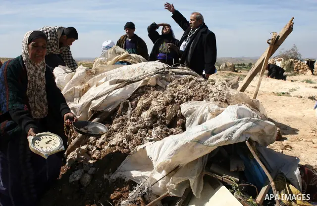 Palestinians are trying to retrieve items from the rubble of their family house after it was destroyed by Israeli army tractors early on 22 February 2011 in the West Bank village of Yatta near Hebron. The house was locat...