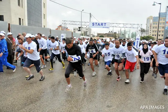 Palestinians participate in a marathon entitled " Charity for them" in the West Bank city of Ramallah November 18, 2011. Photo by Issam Rimawi
