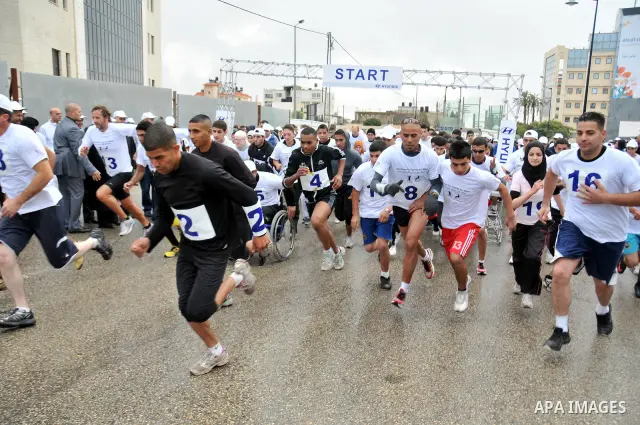 Palestinians participate in a marathon entitled " Charity for them" in the West Bank city of Ramallah November 18, 2011. Photo by Issam Rimawi